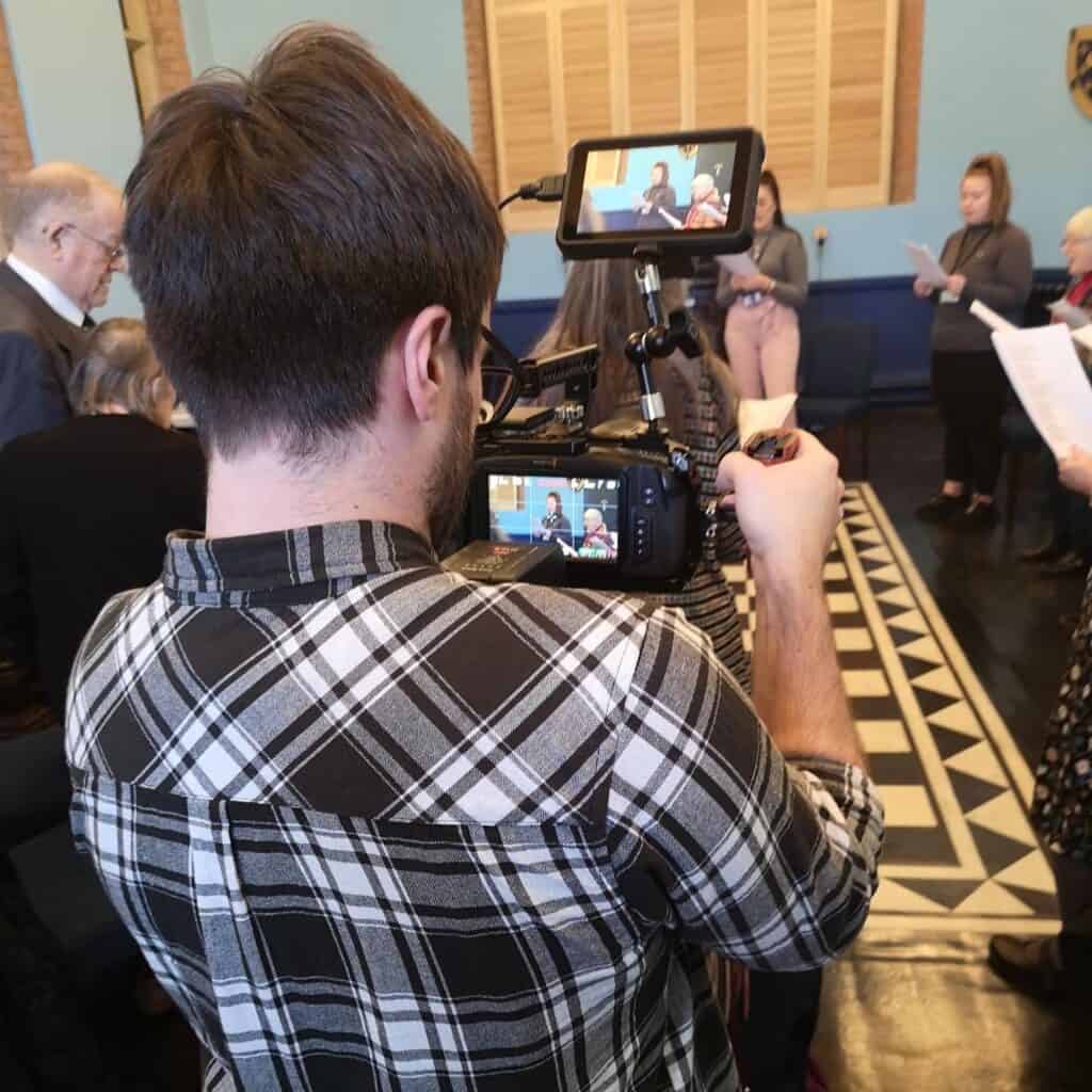 Camera operator and Creative Director from Glacé Media filming the Careers Choir in Stockport alongside the charity Stockport Mind.