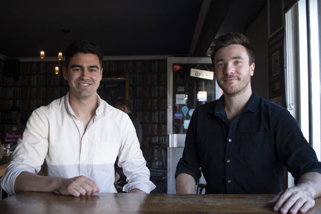 Managing Director (Marcus Johnson) and Creative Director (Matt Green) of Glacé Media sat at a table in a pub smiling at the camera.