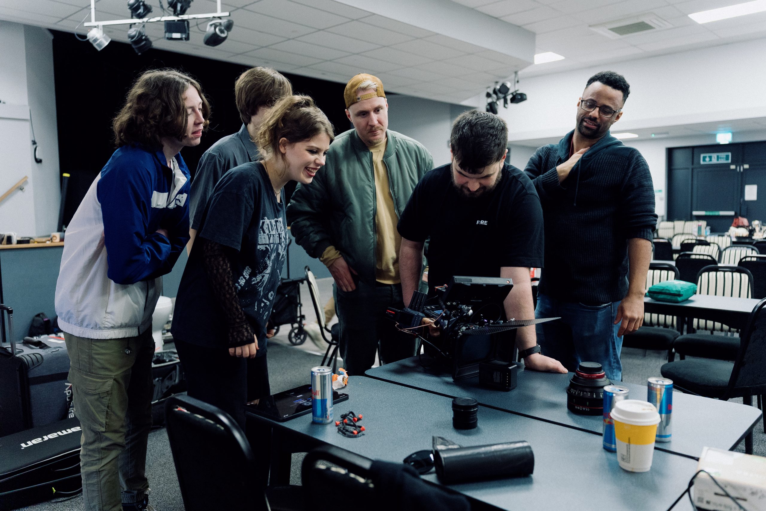 Video and film set featuring team and crew members watching a video for internal communications